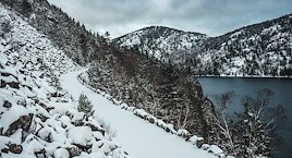 Snow capped mountains with winding path