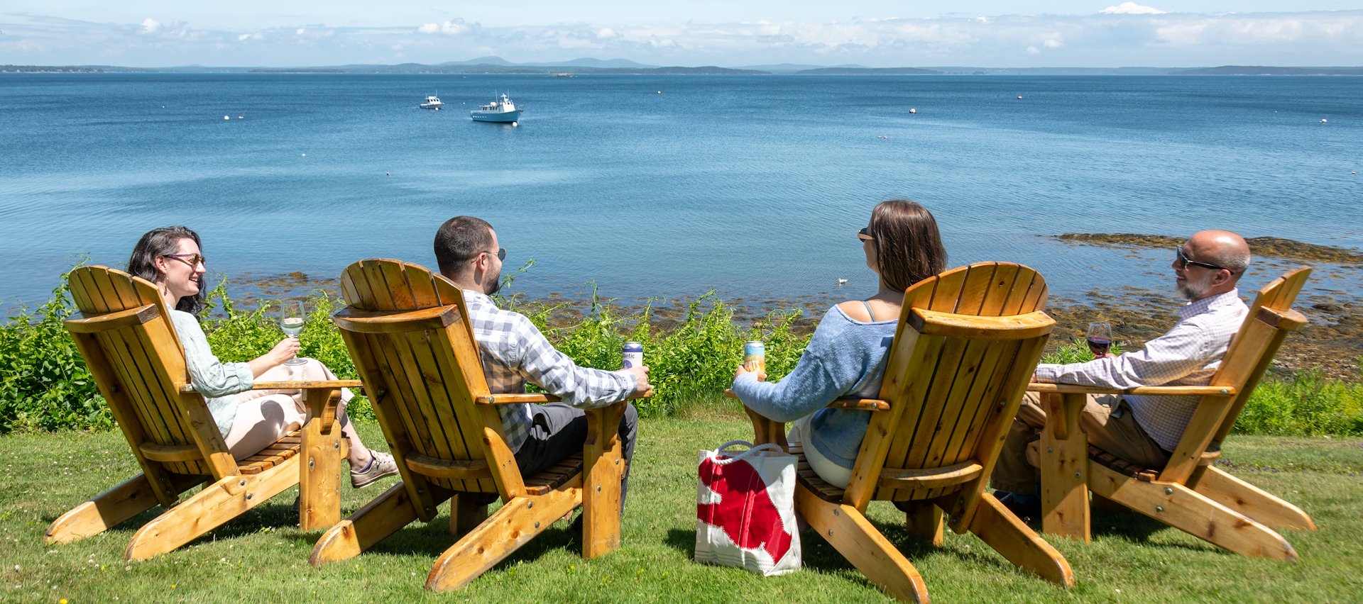 Guests relax by the water at The Bayview Hotel in Bar Harbor, Maine.