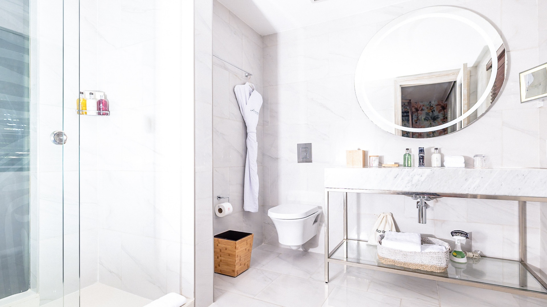 A modern bathroom with a shower, toilet, and sink