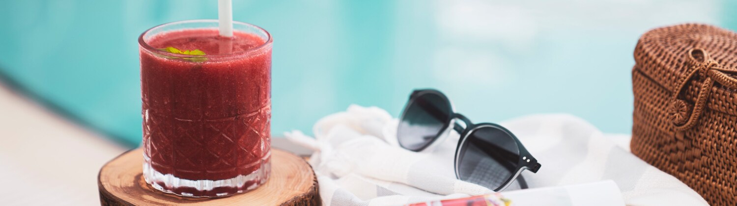 Glass of red drink with magazine and sunglasses, Florida Resort