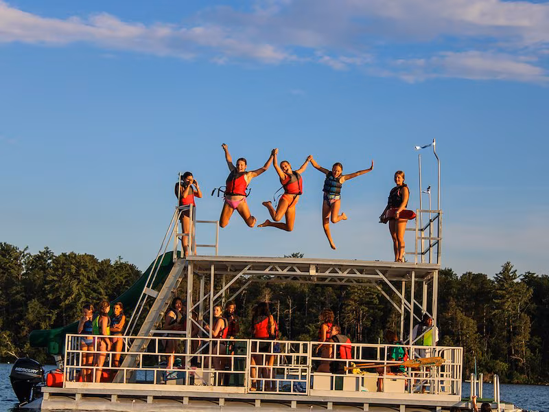 Girls jumping off the boat