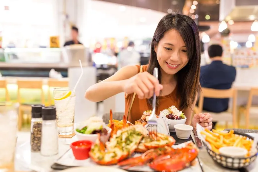 Woman enjoying lobster in a restaurant